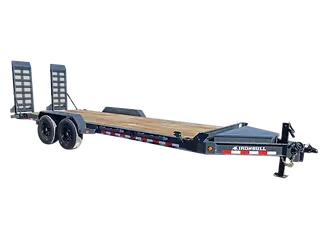 A dual‑axle Ironbull flatbed trailer with a wooden deck and rear loading ramps, designed for hauling equipment or materials.