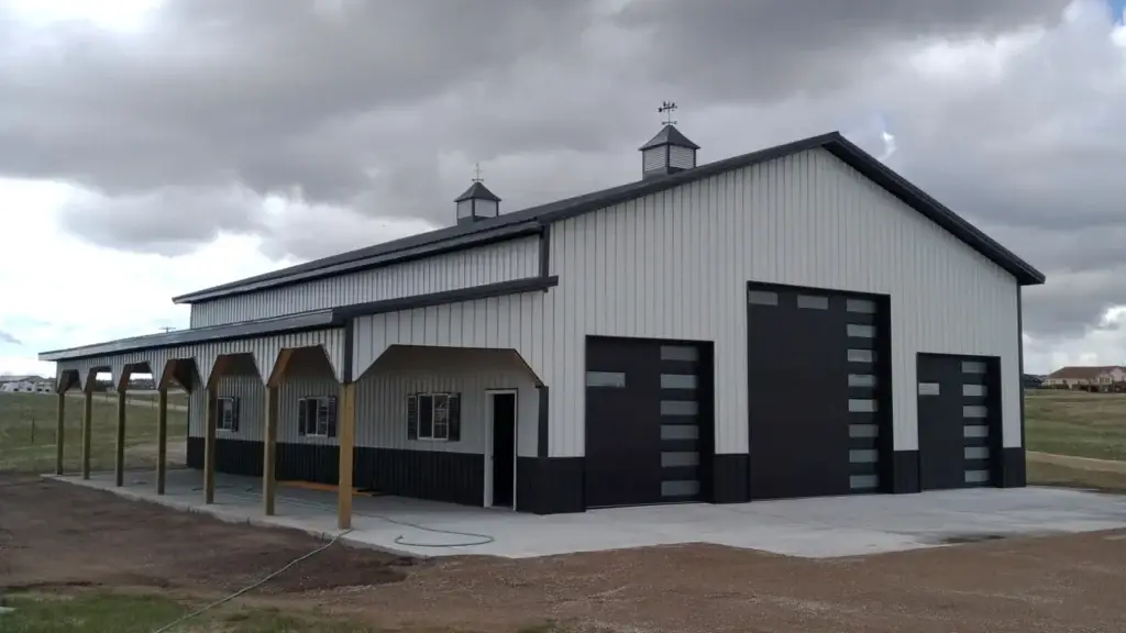 Completed white and gray pole barn with metal exterior